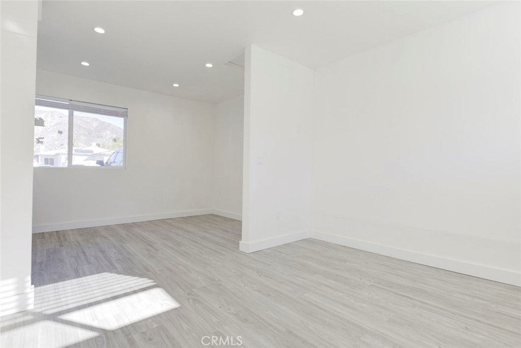 7846 Kyle Street Sunland, CA 91040 - Photo 3 of 12 an empty room with wooden floor and windows