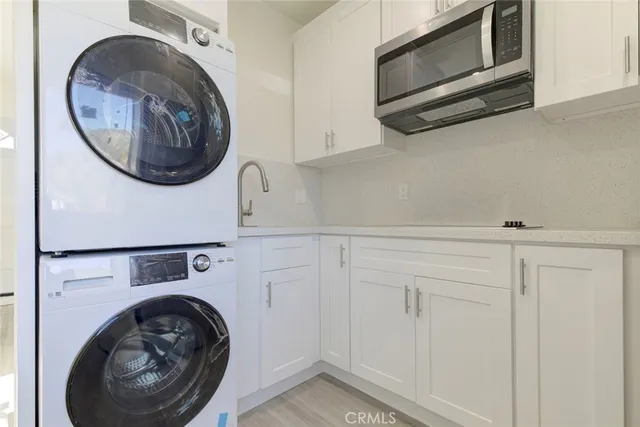 a utility room with sink dryer and washer