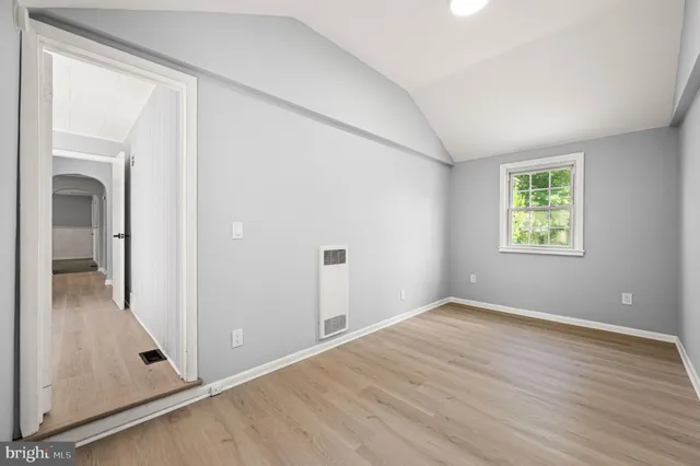 an empty room with windows and closet