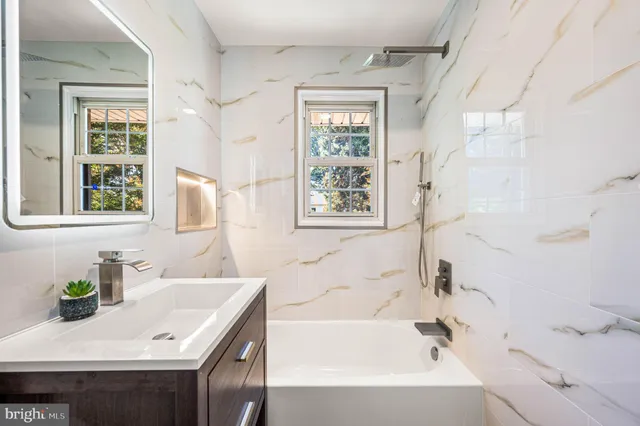 a bathroom with a sink vanity tub and a bathtub