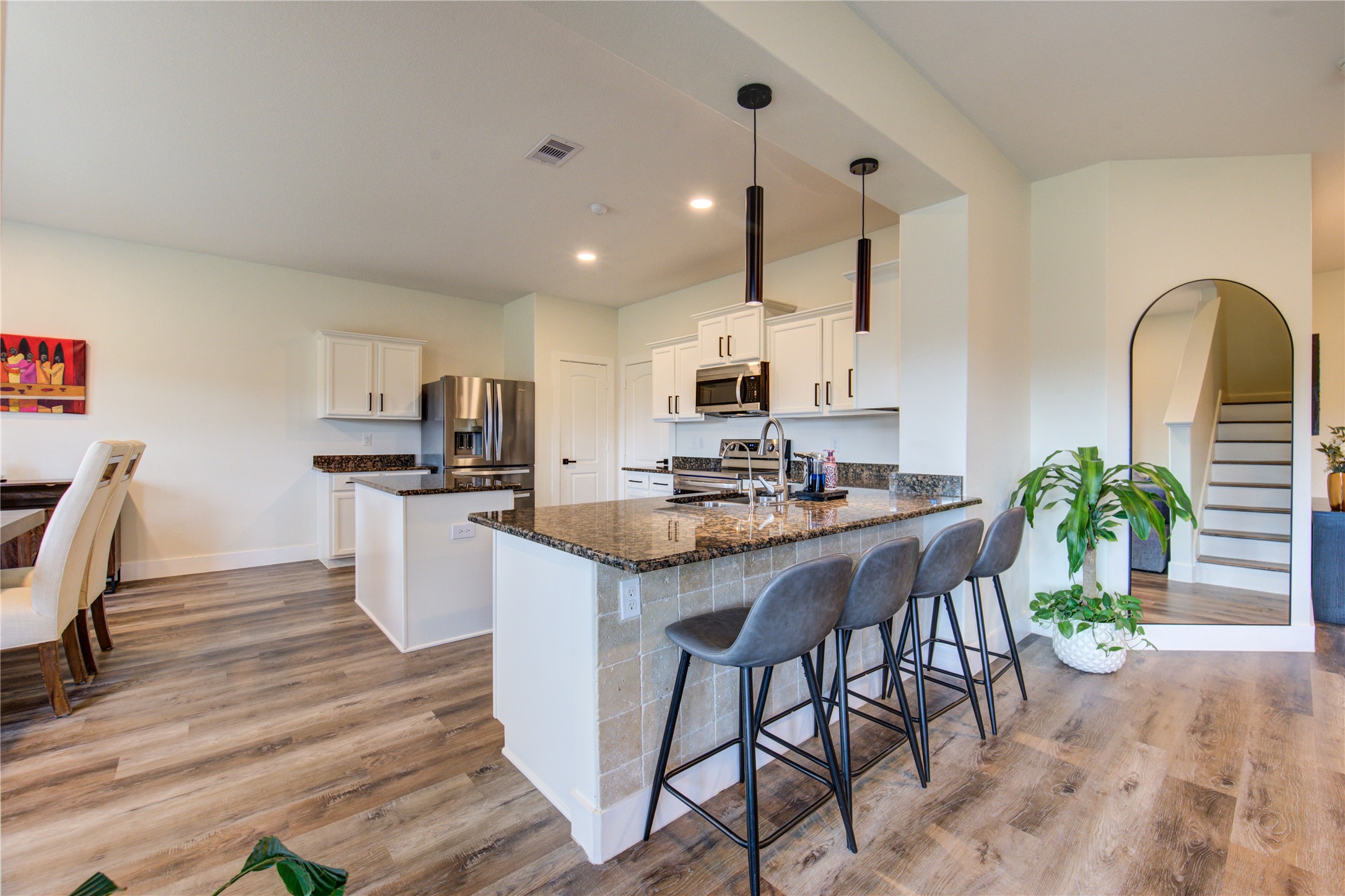2003 Beach Bluff Road Rosenberg, TX 77469 - Photo 19 of 50 a kitchen with granite countertop a table chairs stove and cabinets
