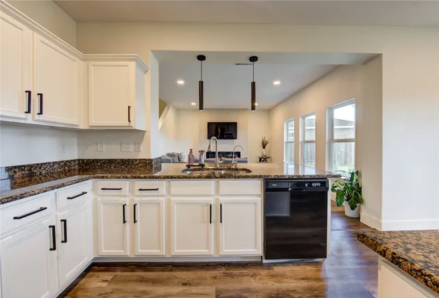 a kitchen with stainless steel appliances granite countertop a stove a sink and a granite counter tops