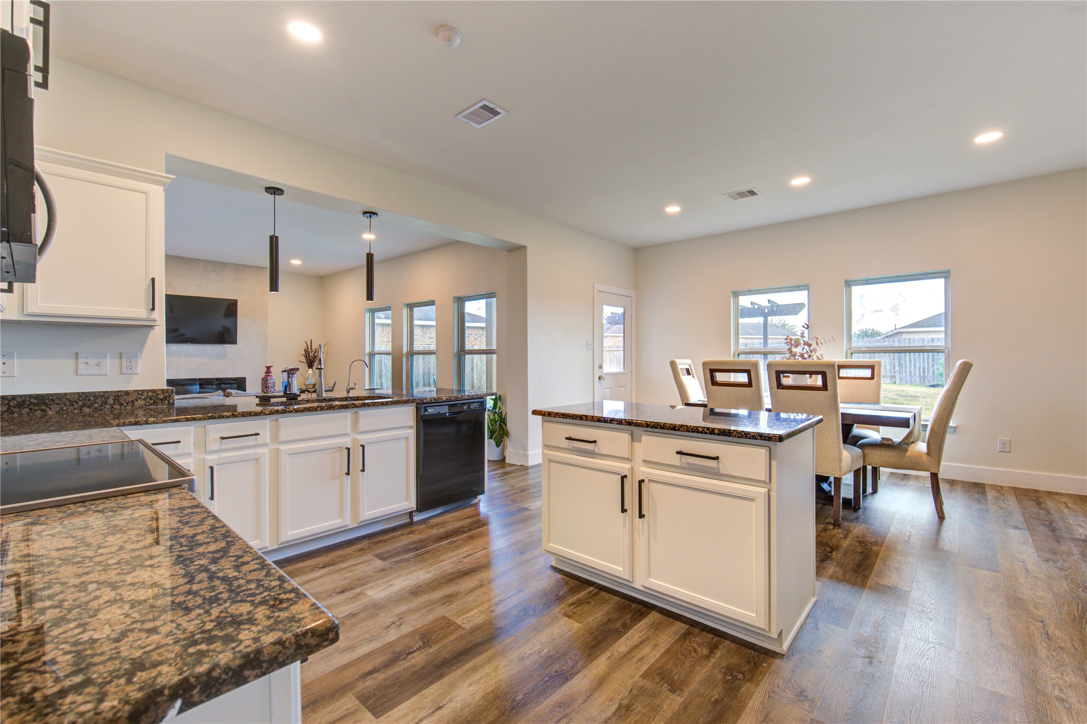 2003 Beach Bluff Road Rosenberg, TX 77469 - Photo 24 of 50 a kitchen with stainless steel appliances kitchen island granite countertop a stove top oven a sink a dining table and chairs