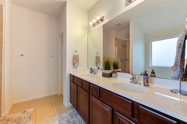 a bathroom with a double vanity sink and a mirror