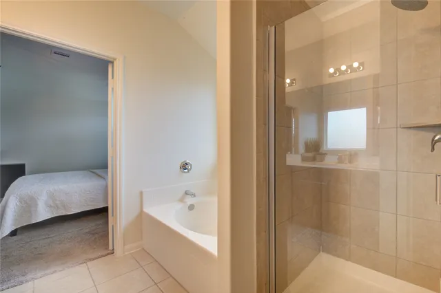 a bathroom with a bathtub and shower