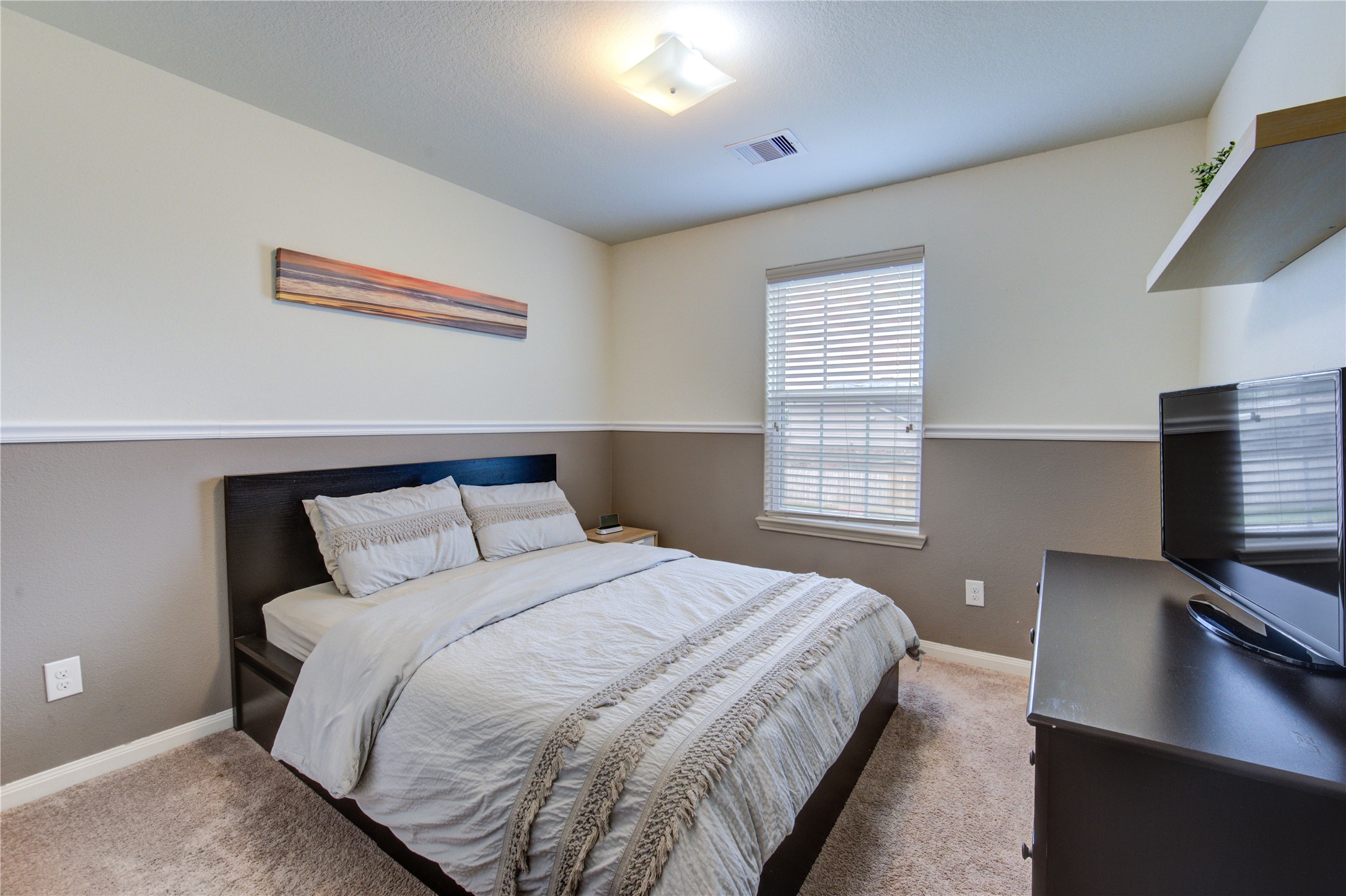 2003 Beach Bluff Road Rosenberg, TX 77469 - Photo 42 of 50 a bedroom with a bed and a flat tv screen on a dresser