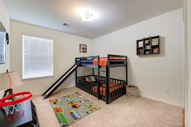 a bedroom with furniture and a window