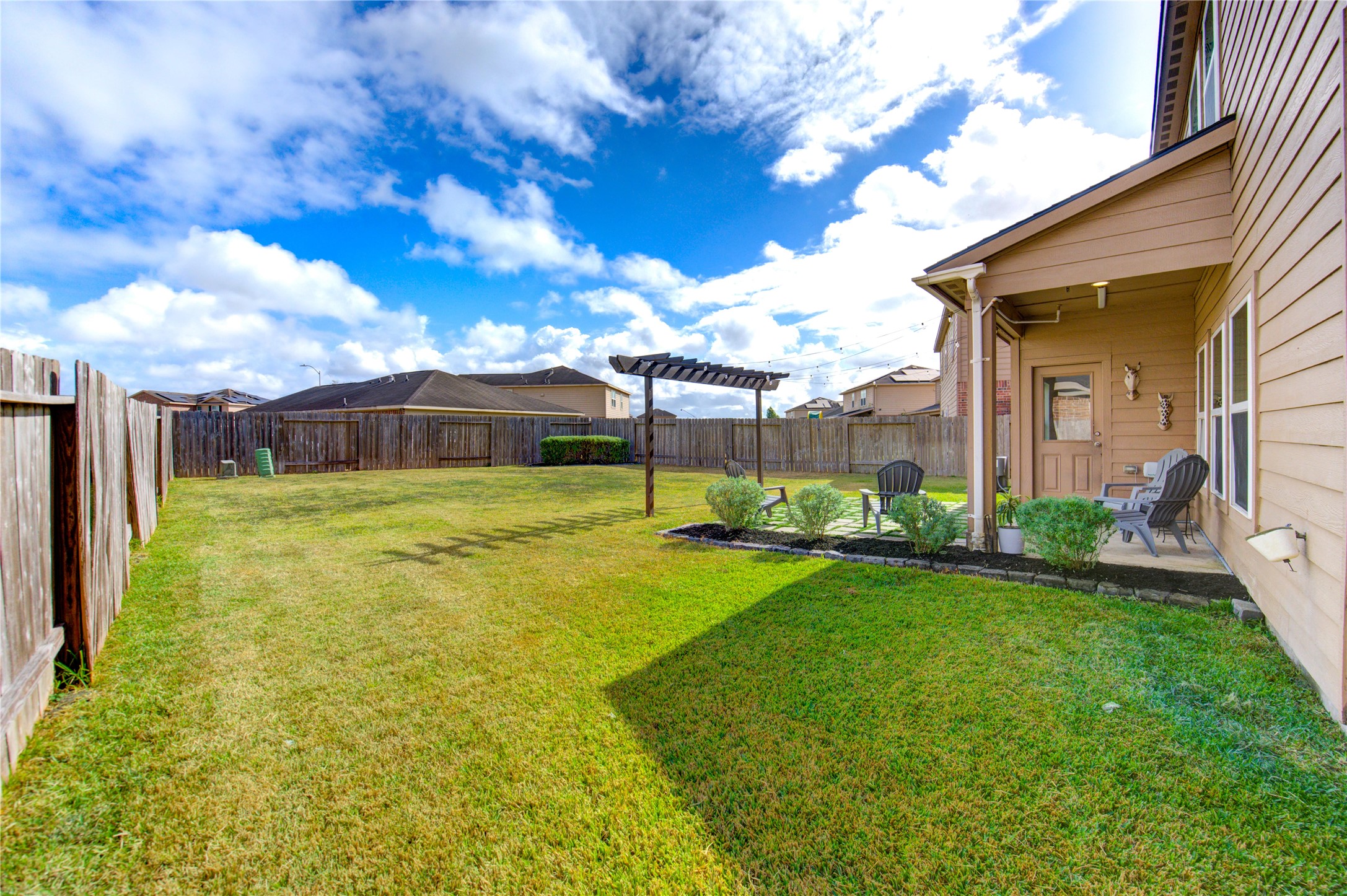 2003 Beach Bluff Road Rosenberg, TX 77469 - Photo 49 of 50 a view of a house with a big yard potted plants and a large tree