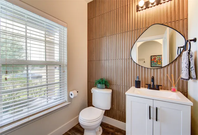 a bathroom with a toilet a sink and a mirror