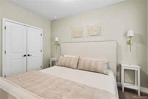 a bedroom with a bed and cabinets