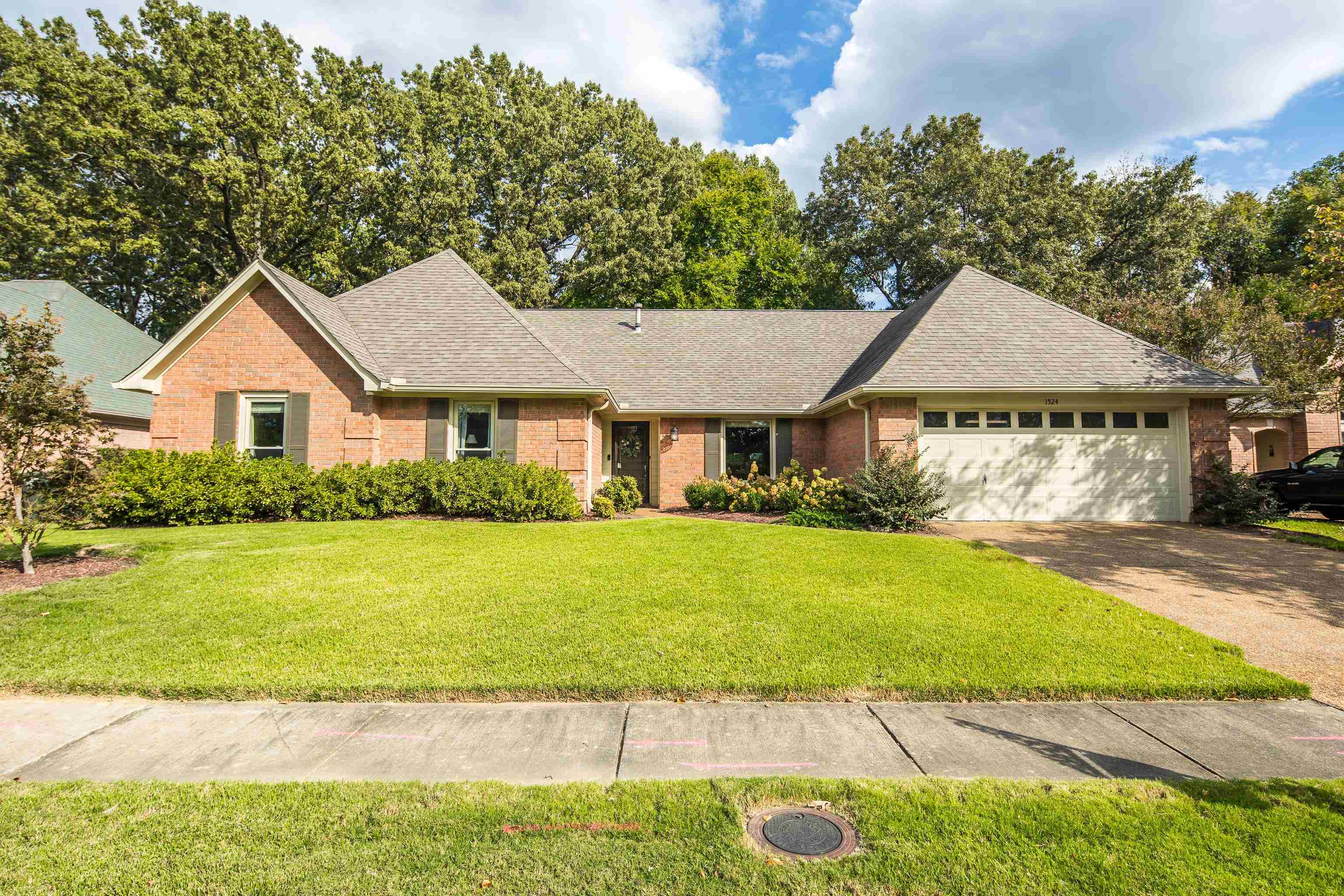 Ranch-style home with a garage and a front lawn