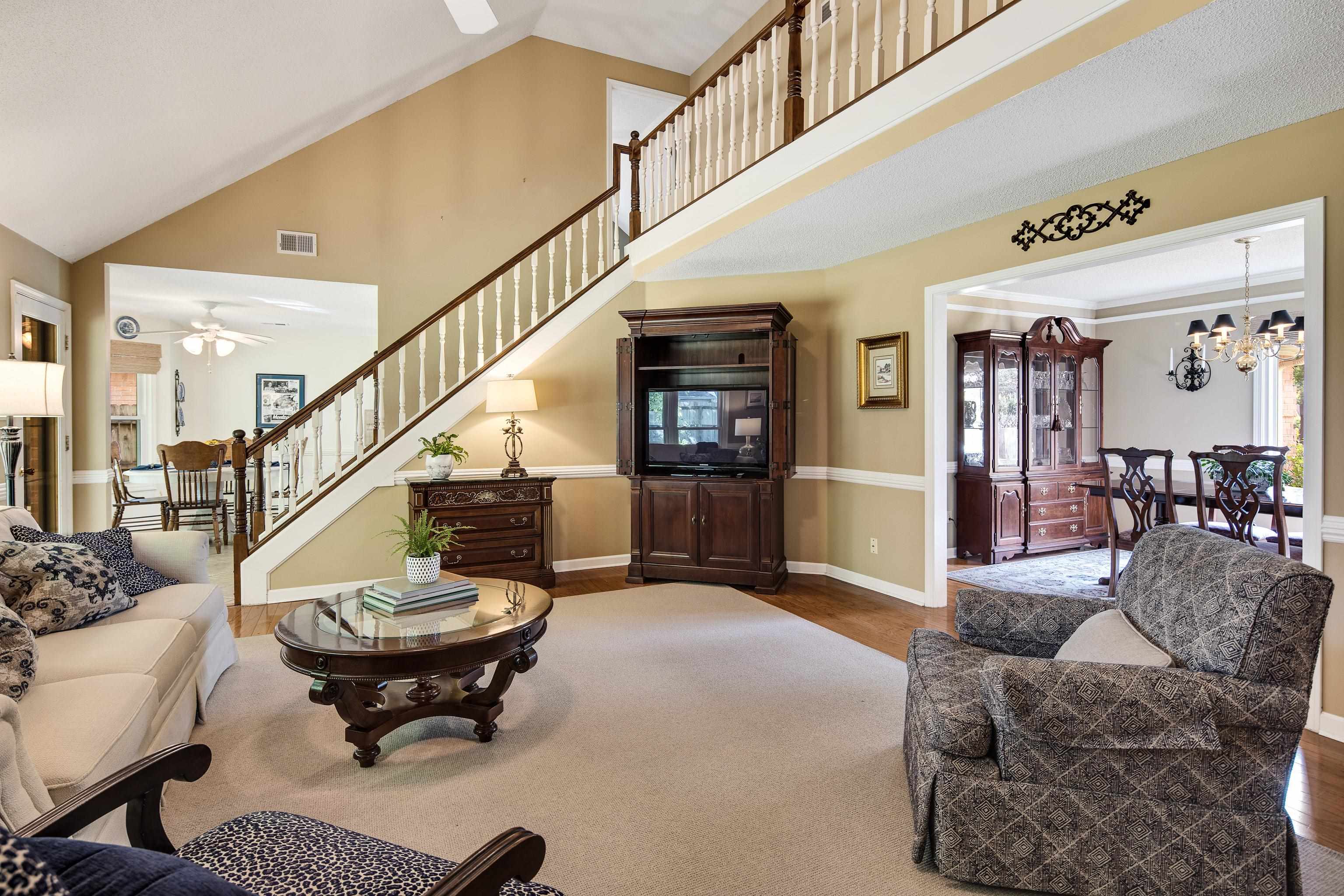 1524 Dexter Run Circle East Memphis, TN 38016 - Photo 13 of 35 Living room with ceiling fan with notable chandelier, high vaulted ceiling, and hardwood / wood-style flooring