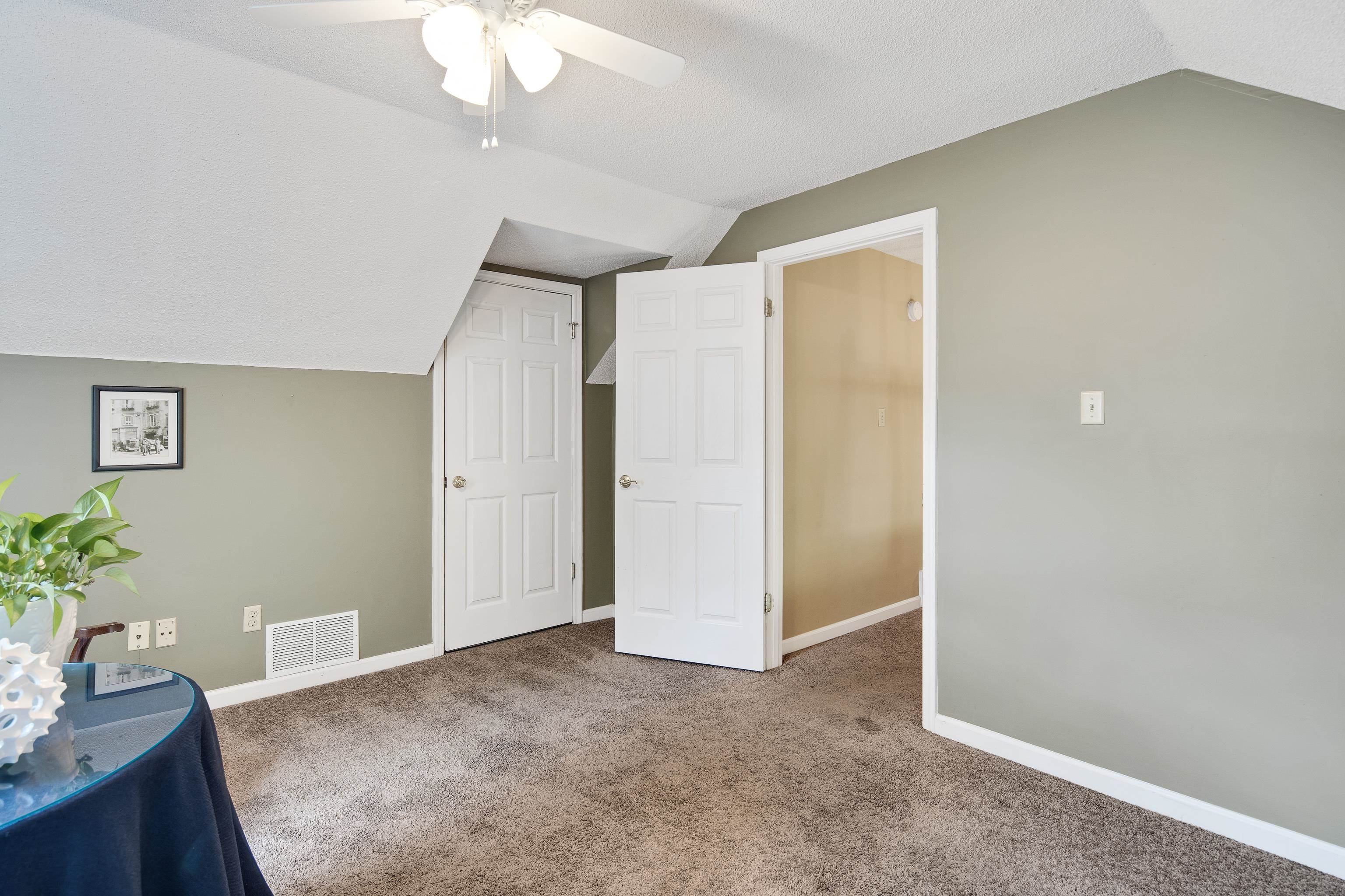 1524 Dexter Run Circle East Memphis, TN 38016 - Photo 31 of 35 Unfurnished room featuring ceiling fan, carpet floors, vaulted ceiling, and a textured ceiling