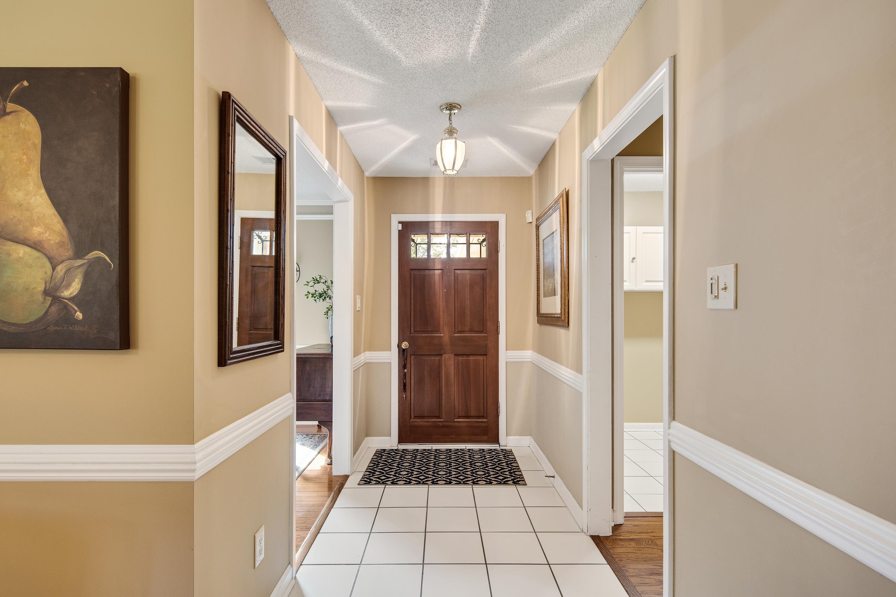 Entrance foyer featuring light hardwood / wood-style floors and a textured ceiling