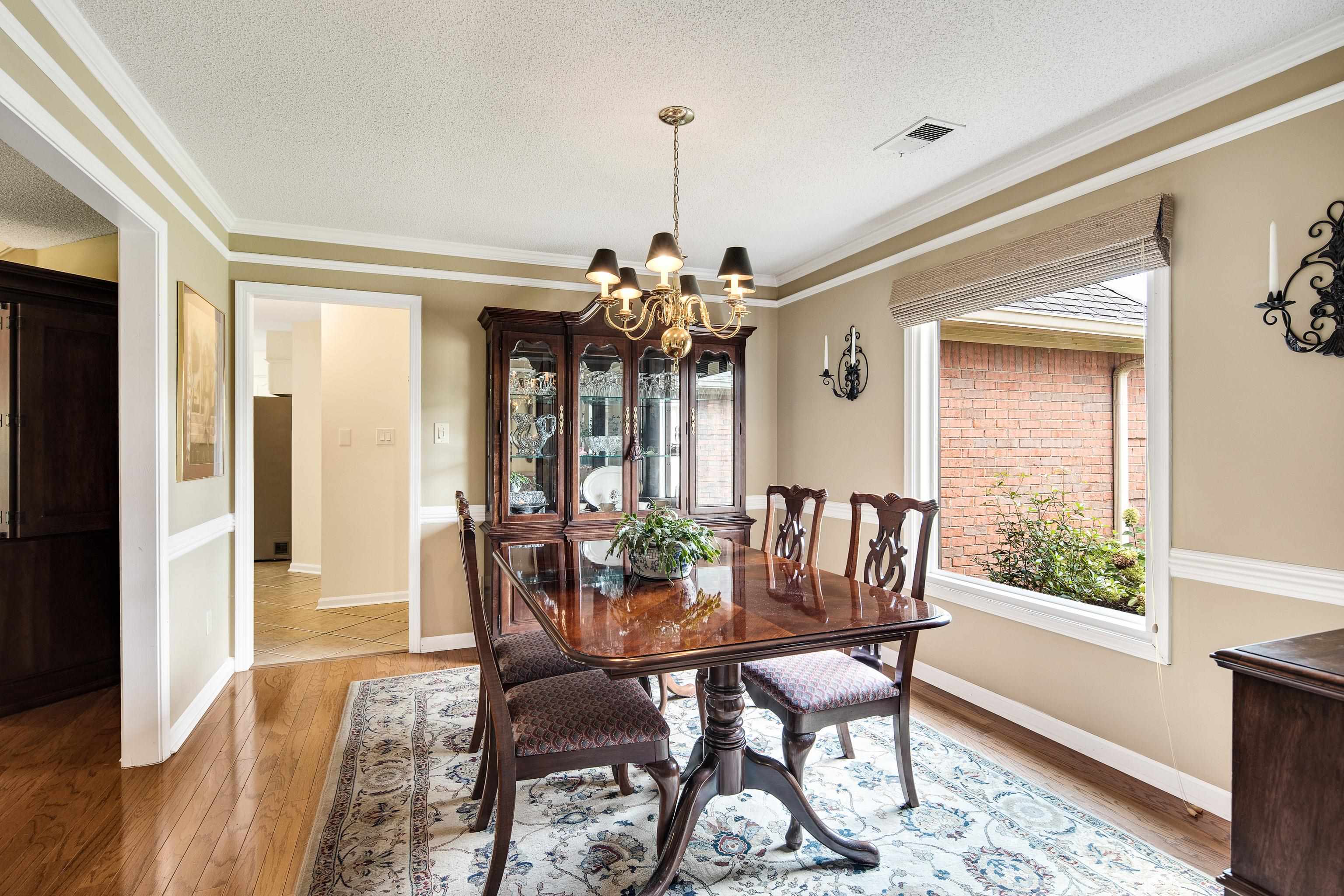 1524 Dexter Run Circle East Memphis, TN 38016 - Photo 8 of 35 Dining room featuring a textured ceiling, light hardwood / wood-style flooring, plenty of natural light, and ornamental molding