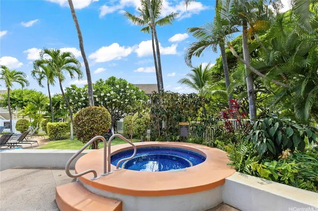 a view of a swimming pool with a yard potted plants