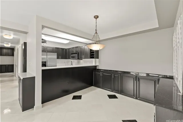 a kitchen with kitchen island a counter top space appliances and cabinets