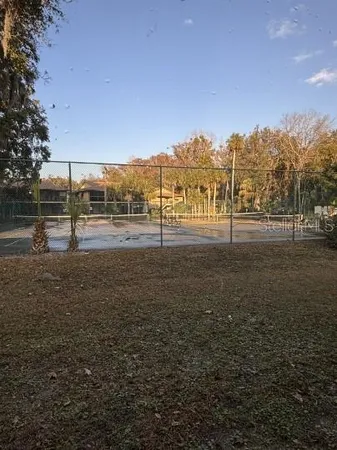 a white house that has a tree in front of it