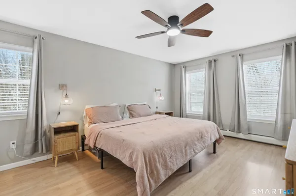 a bedroom with a bed and a large window