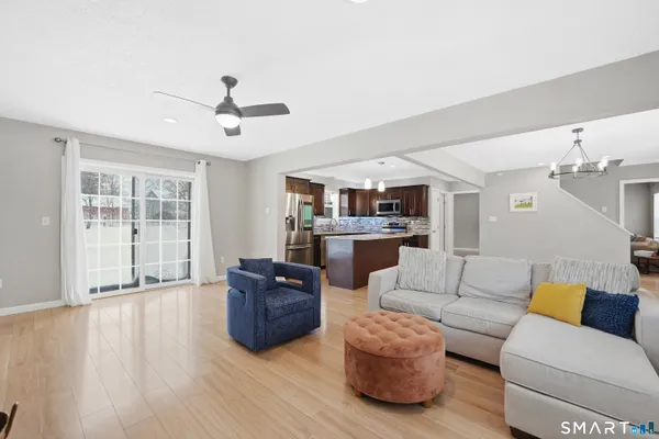 a living room with furniture and kitchen view