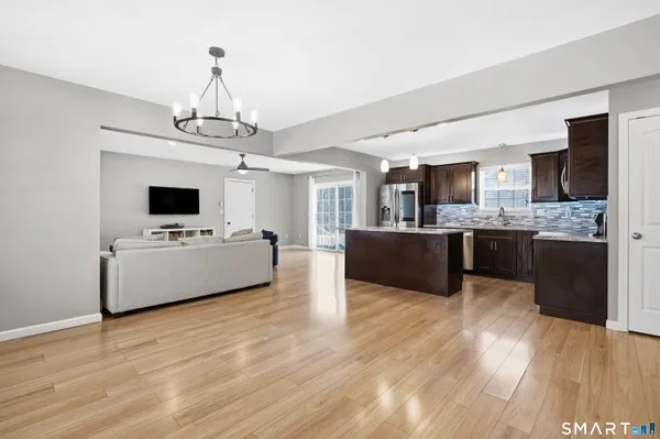 a view of kitchen with sink microwave and refrigerator