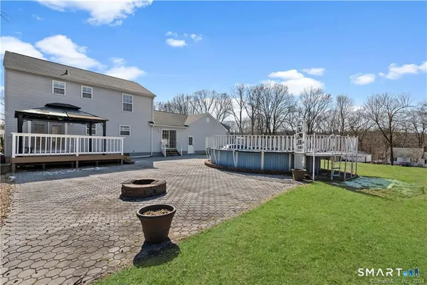 a view of a porch with furniture and a tree