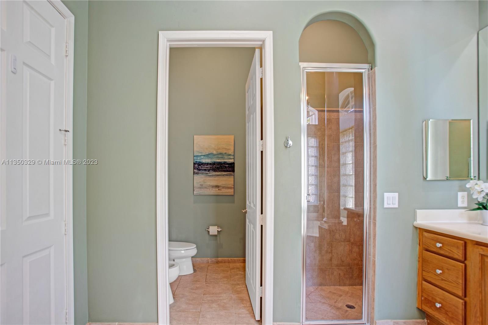 3060 Southwest 195th Terrace Miramar, FL 33029 - Photo 16 of 76 a bathroom with a granite countertop sink a mirror and a toilet