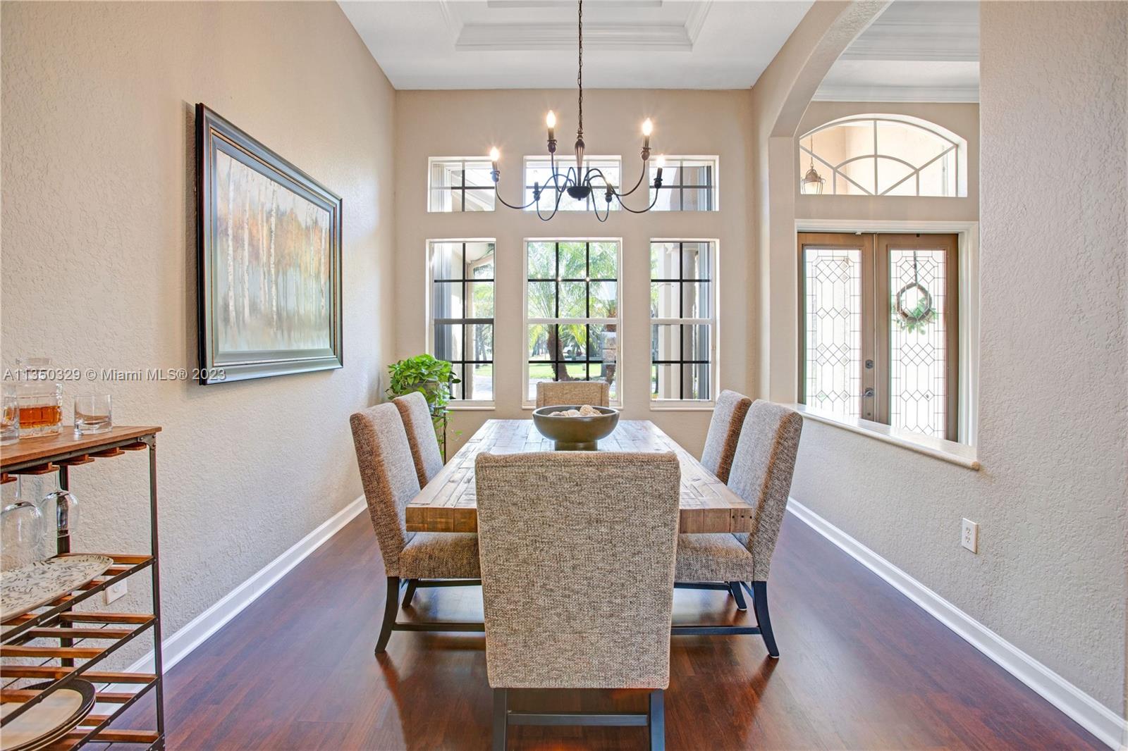 3060 Southwest 195th Terrace Miramar, FL 33029 - Photo 20 of 76 a dining room with furniture a chandelier and wooden floor