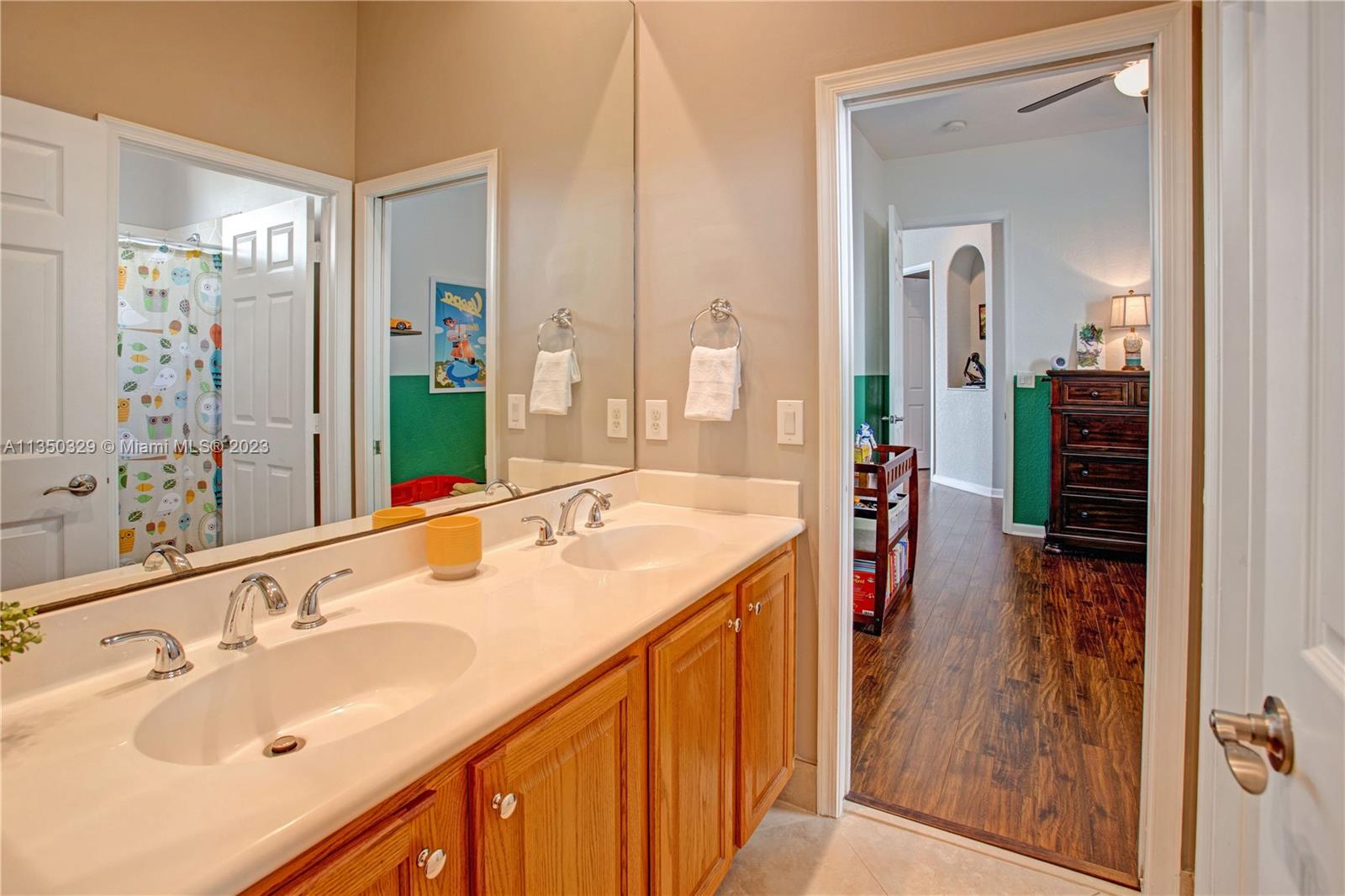 3060 Southwest 195th Terrace Miramar, FL 33029 - Photo 27 of 76 a en suite bathroom with a sink a mirror and shower