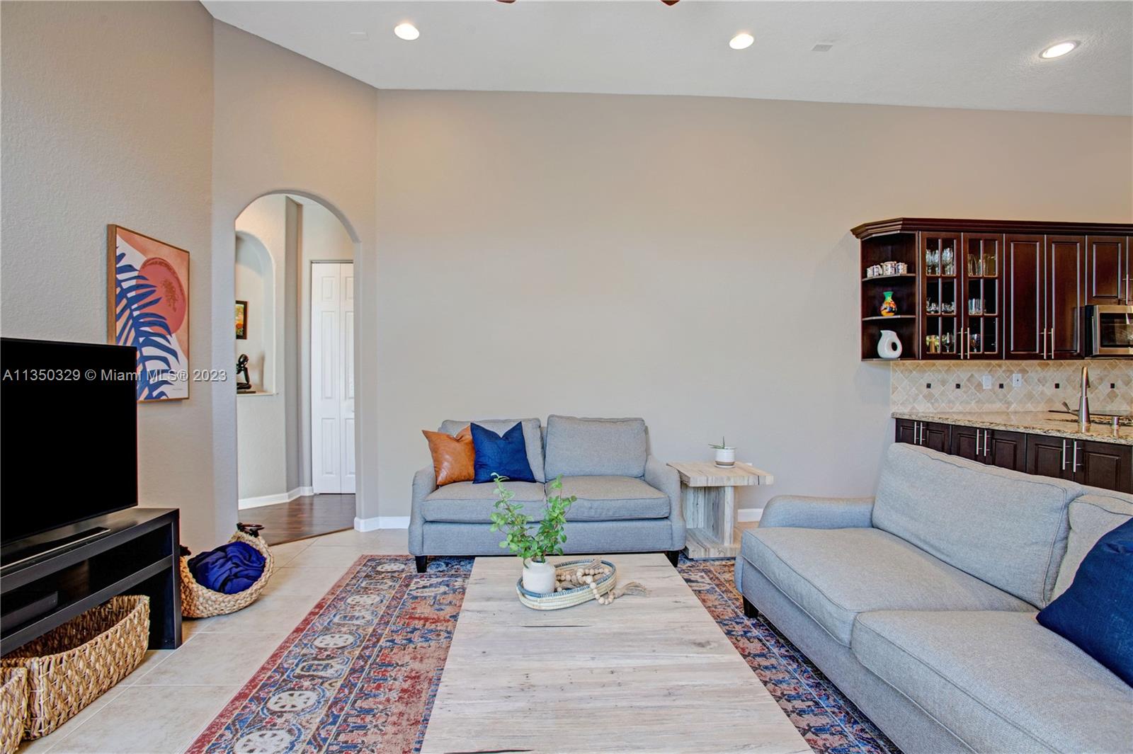 3060 Southwest 195th Terrace Miramar, FL 33029 - Photo 38 of 76 a living room with furniture and a flat screen tv