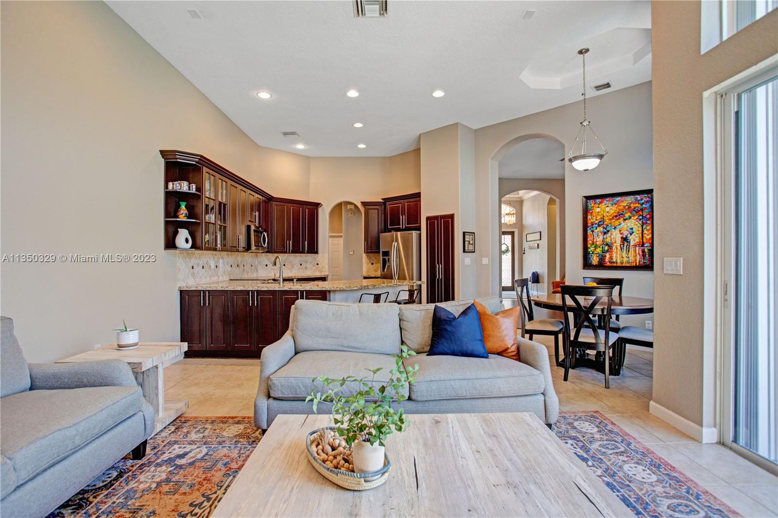 3060 Southwest 195th Terrace Miramar, FL 33029 - Photo 41 of 76 a living room with furniture kitchen view and a wooden floor