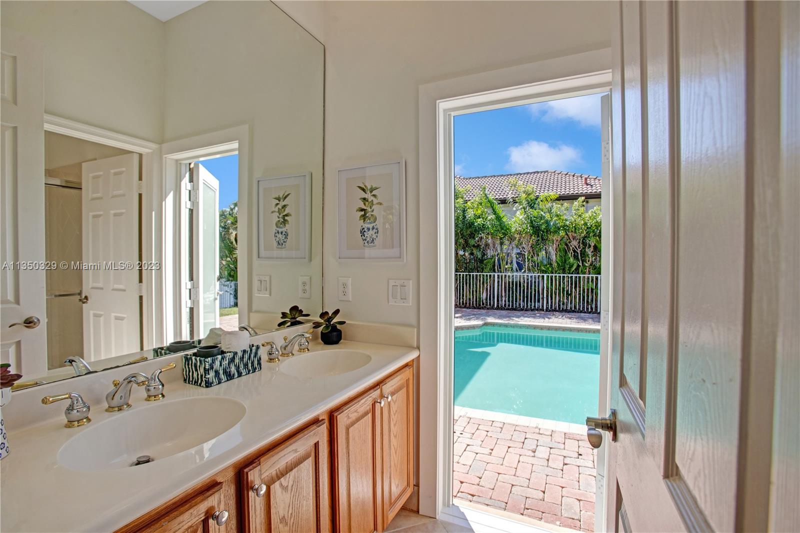 3060 Southwest 195th Terrace Miramar, FL 33029 - Photo 47 of 76 a bathroom with a sink and a mirror