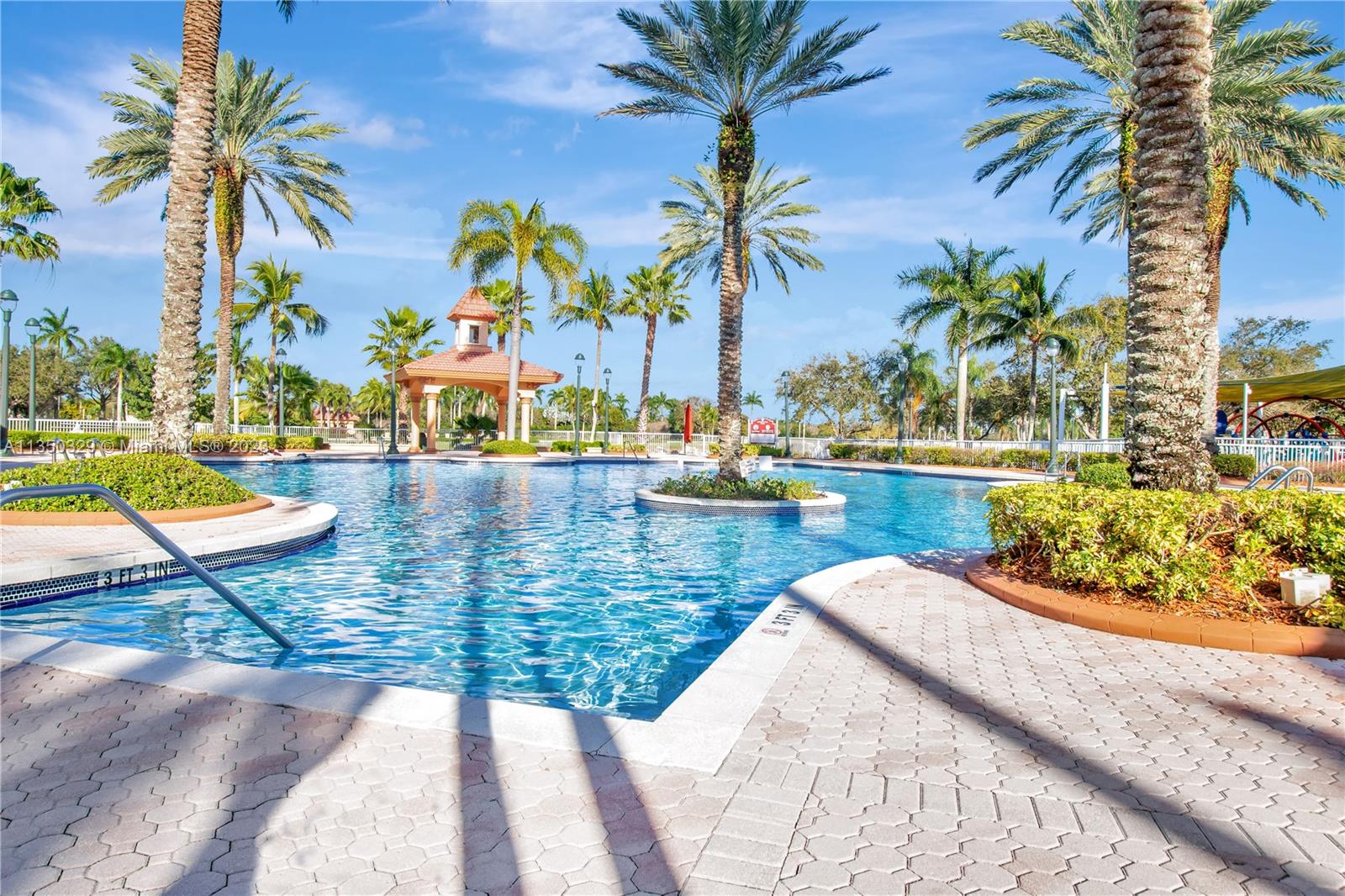 3060 Southwest 195th Terrace Miramar, FL 33029 - Photo 60 of 76 a view of swimming pool with a lounge chair and palm trees