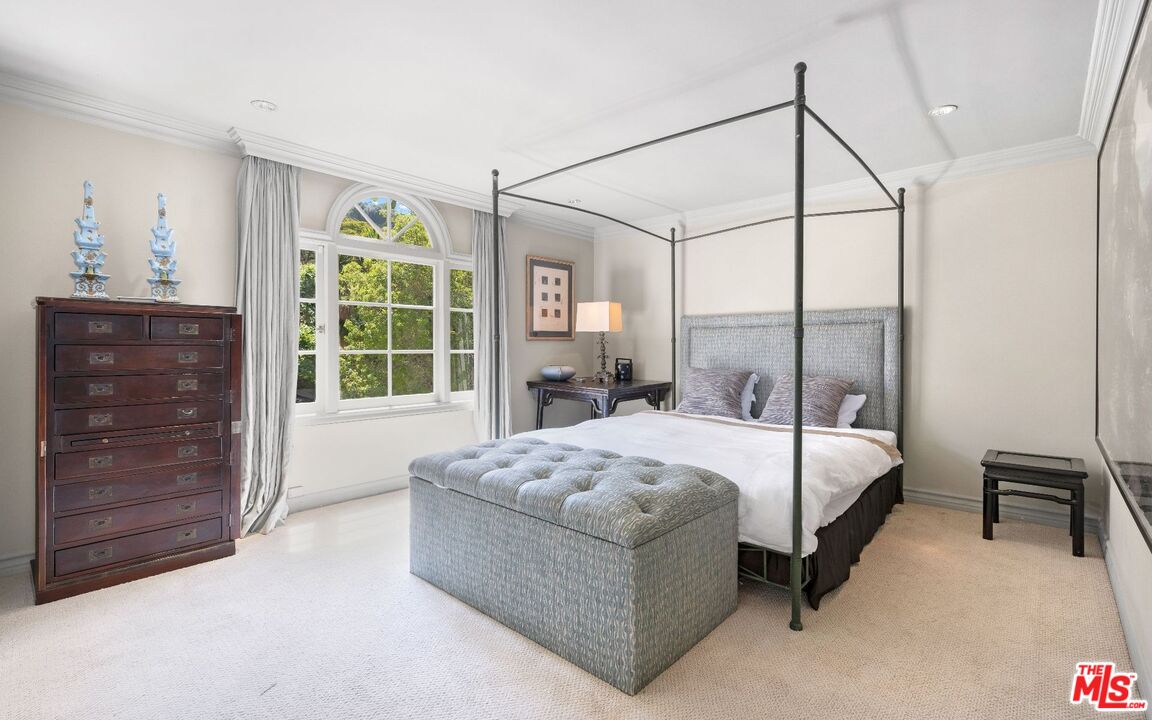 1241 Stone Canyon Road Los Angeles, CA 90077 - Photo 7 of 12 a bedroom with a bed and a dresser