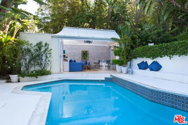 a view of house with outdoor space and swimming pool