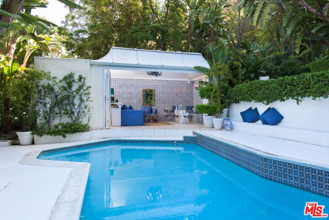 1241 Stone Canyon Road Los Angeles, CA 90077 - Photo 9 of 12 a view of house with outdoor space and swimming pool