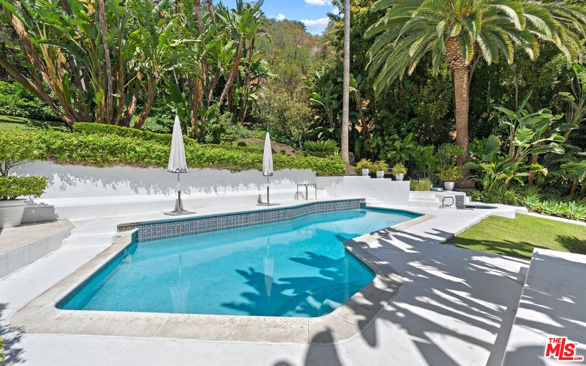 1241 Stone Canyon Road Los Angeles, CA 90077 - Photo 10 of 12 a view of a swimming pool with a patio