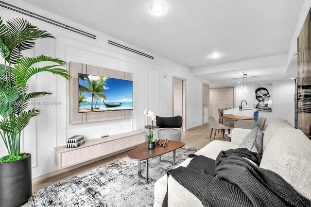 a living room with furniture and a potted plant