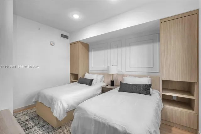 a bedroom with two beds and painted walls