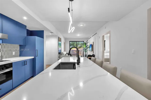a large white kitchen with wooden floors and floors