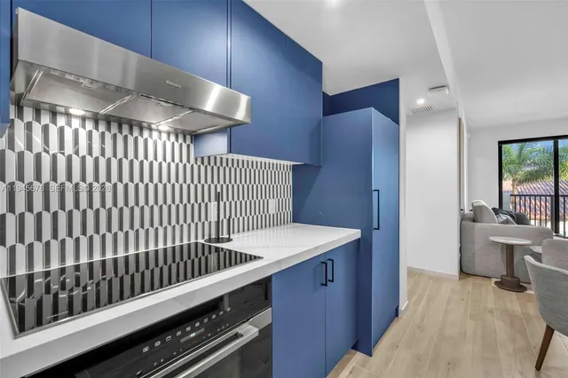 a view of a hallway with a kitchen
