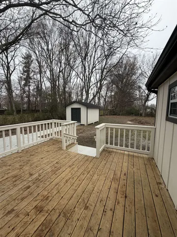 a view of deck with wooden floor and fence