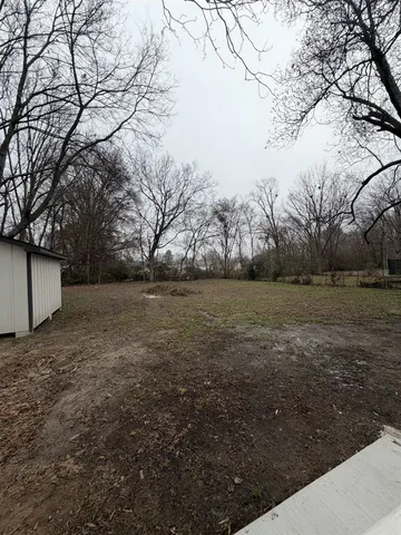 a view of a backyard of the house