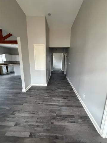 a view of entryway and hall with wooden floor