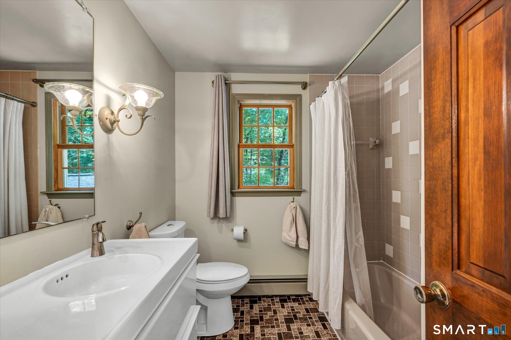 59 Indian Hill Road Canton, CT 06019 - Photo 21 of 39 a bathroom with a sink toilet a mirror and shower