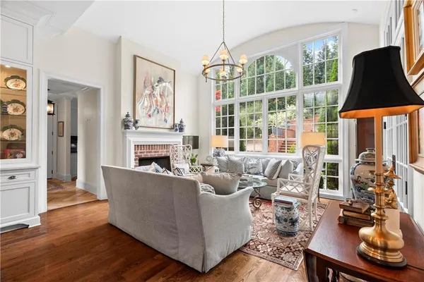 a living room with furniture and a large window with wooden floor