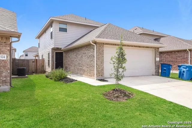 a white house with a small yard and a small yard