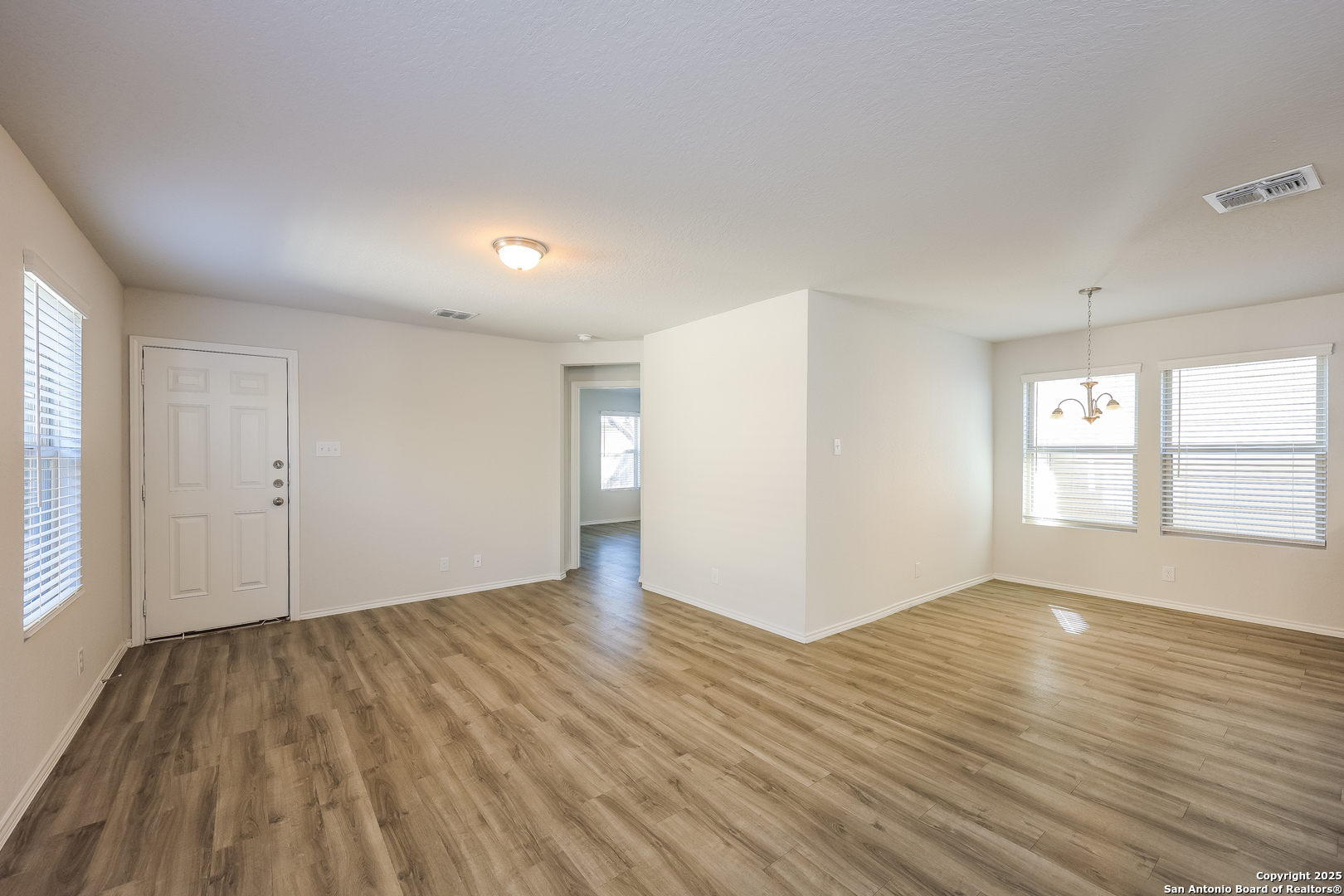 10328 Green Branch San Antonio, TX 78223 - Photo 4 of 16 an empty room with wooden floor and windows