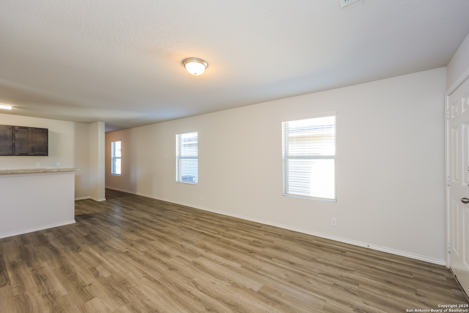 10328 Green Branch San Antonio, TX 78223 - Photo 5 of 16 an empty room with wooden floor and windows