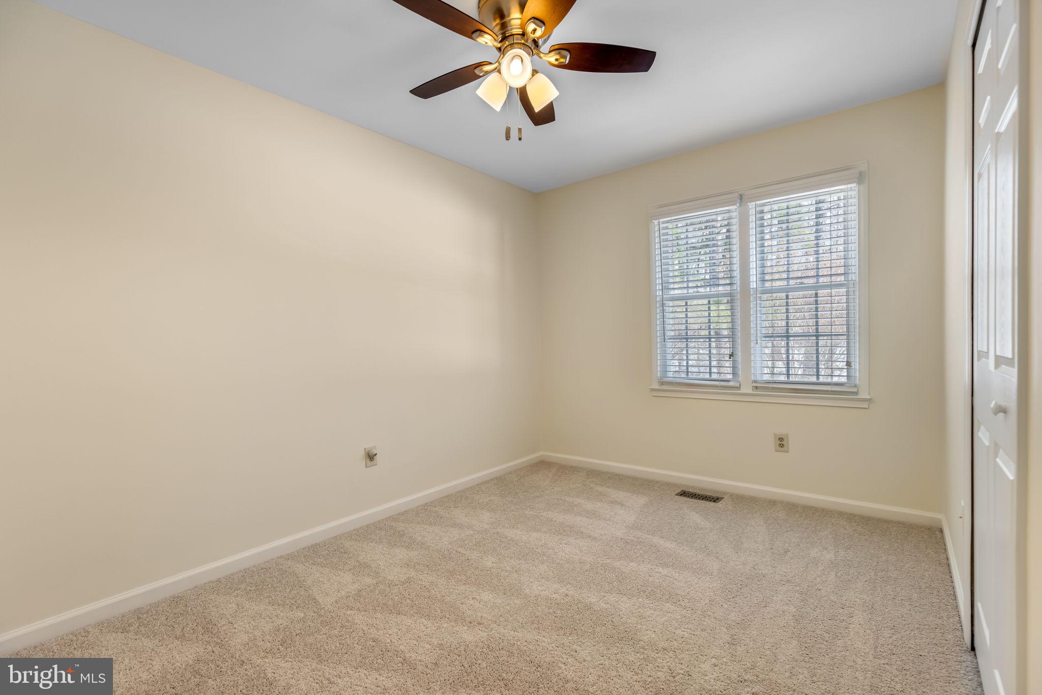 8371 Luce Court Springfield, VA 22153 - Photo 14 of 21 an empty room with chandelier fan and windows